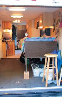 Inside the toy hauler that Judith, Gabor and Erin lived in. Two beds and a small kitchen 